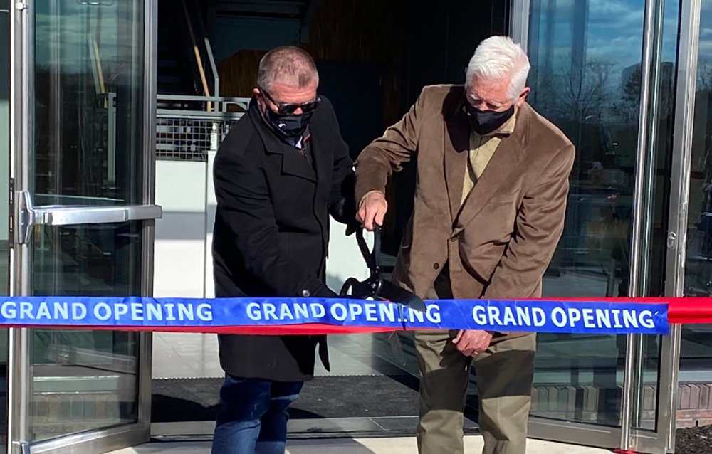 Kevin O’Sullivan (left), CEO and President of Tower Holdings Group, cuts the ribbon for the company’s new Stewart Logistics Center with Town of Montgomery Deputy Supervisor Ron Feller (right).