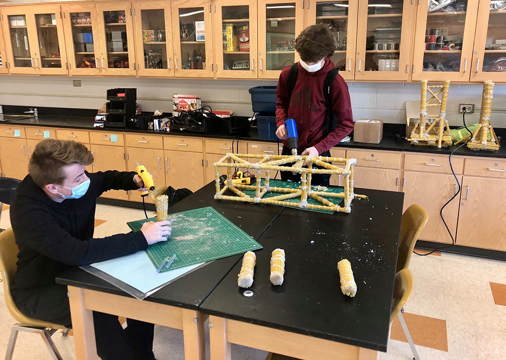 Spaghetti suspension bridges that were designed by Marlboro High School Engineering & Robotics students are almost ready to be assembled.