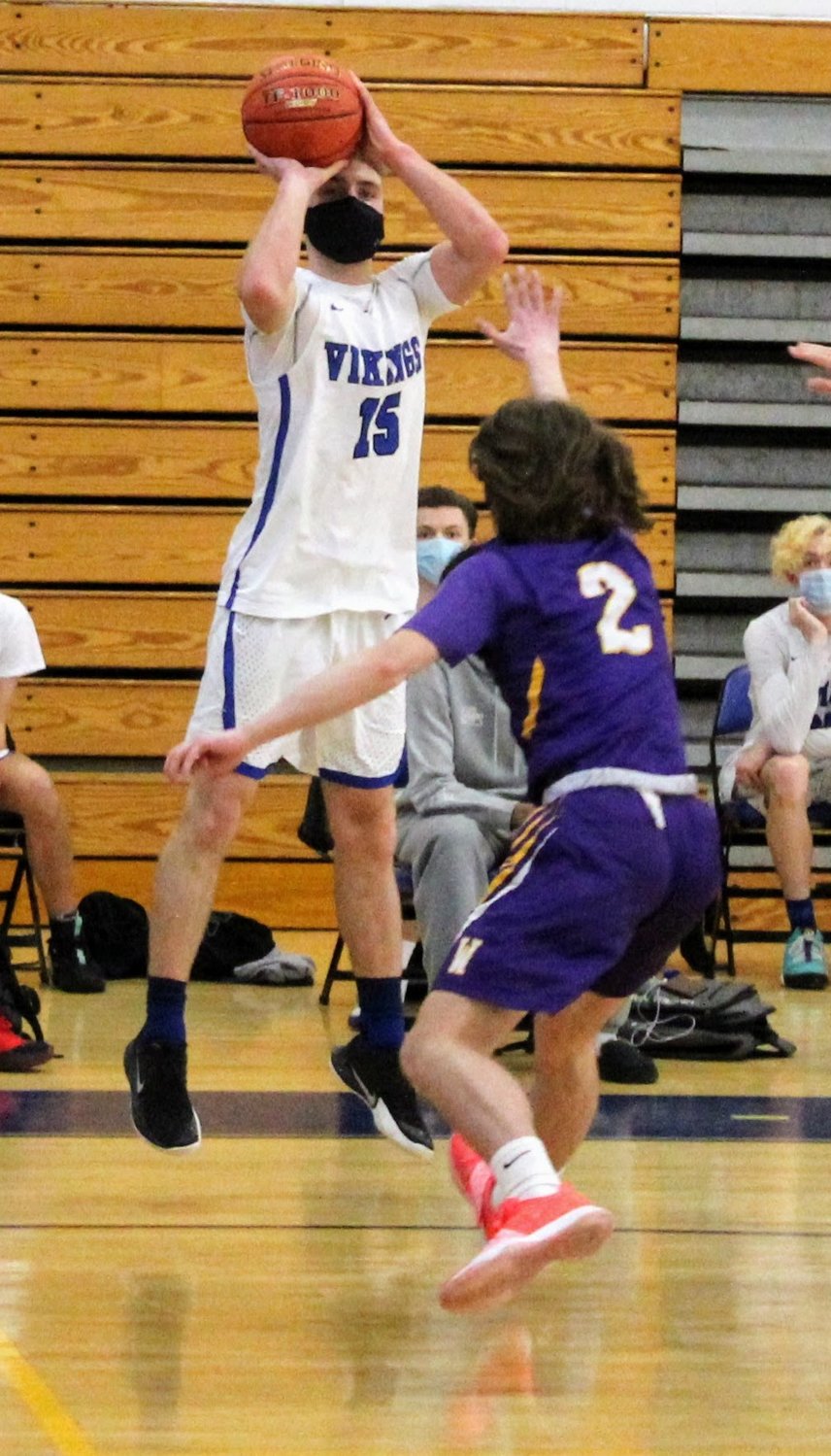 Valley Central’s Zach Bealer shoots over Warwick’s Sean Cosgrove during Wednesday’s boys’ basketball game at Valley Central High School in Montgomery.