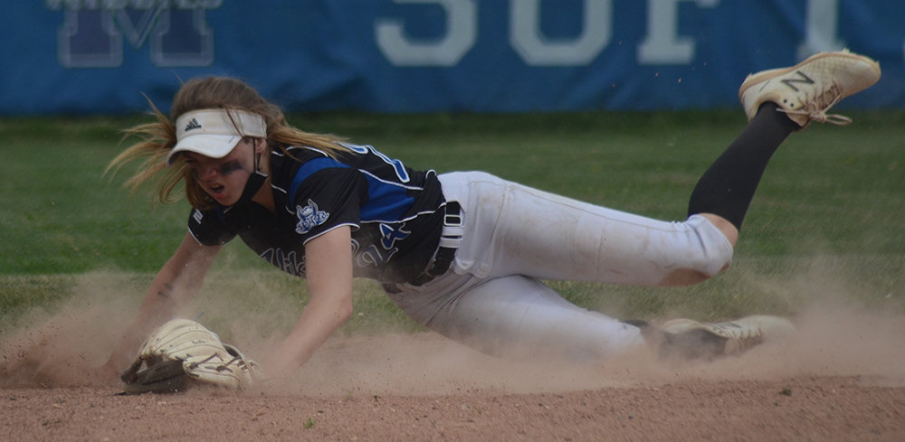 Valley Central shortstop Emilia Brundage dives as a ground ball gets past her during Saturday’s OCIAA softball game at Middletown High School.