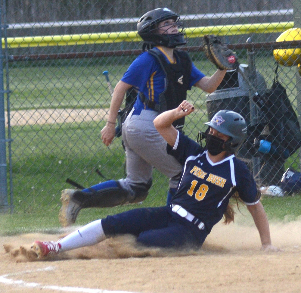 Pine Bush’s Jessica Fowler slides into home as Washingtonville catcher Alexia Punch waits for the throw during Wednesday’s OCIAA Division II game at Crawford Town Park in Pine Bush.