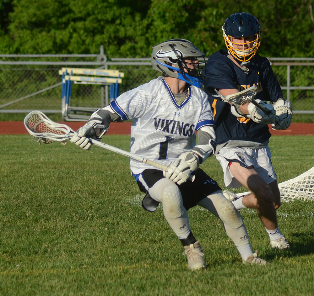 Valley Central’s Dan McClure takes the ball around the net as Highland’s Shaun Piegari defends during Friday’s boys’ lacrosse game.