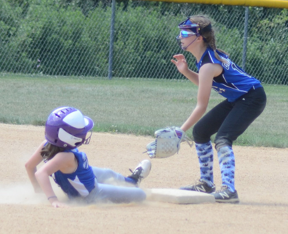Town of Newburgh-New Windsor’s Lillian Wood slides into second base as Wallkill Area’s Ava Chiavaro waits for the throw during Sunday’s District 19 game.