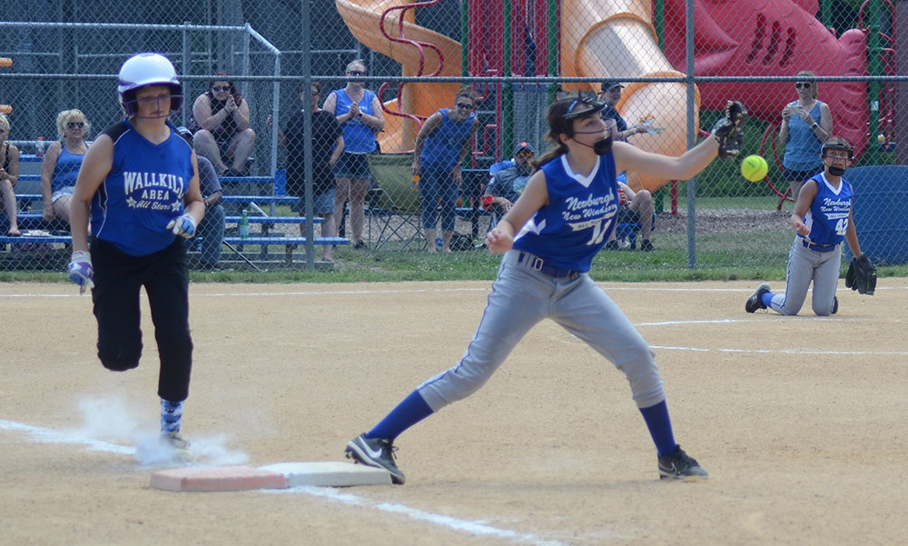 Town of Newburgh-New Windsor first baseman Peyton Ingram tries to come up with a ball thrown by pitcher Giavanna Alphonse as Wallkill Area runner Rachael Sokota reaches first base during Sunday’s District 19 Minors softball game at Town of Wallkill.
