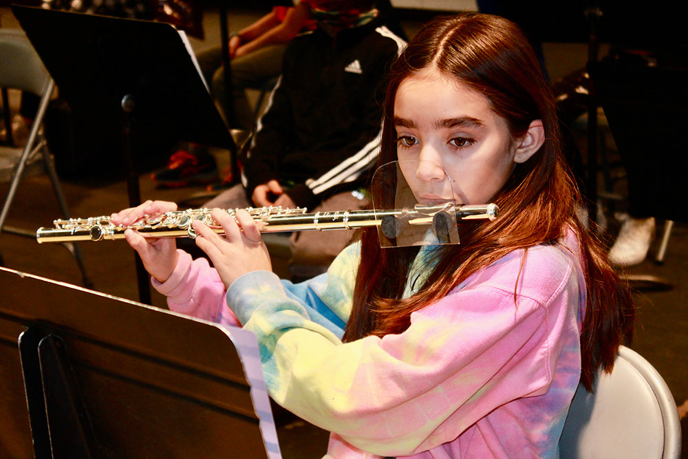 Grade 5 Plattekill Elementary School student Jordan Ortiz playing the flute during a rehearsal for her band’s Winter Concert, which took place on December 16. Her flute is outfitted with a plastic shield as a precaution against the spread of COVID-19.