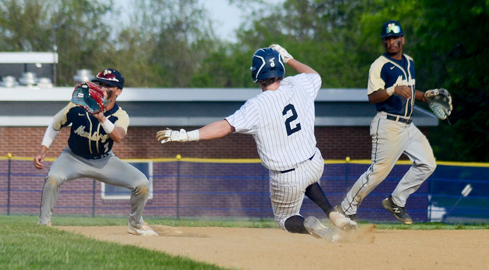 Pine Bush’s Jack Taylor slides into second base as Newburgh second baseman Tyler Martin takes the throw and shortstop Joe Alicea looks on during Friday’s OCIAA crossover baseball game at E.J. Russell Elementary School in Pine Bush.
