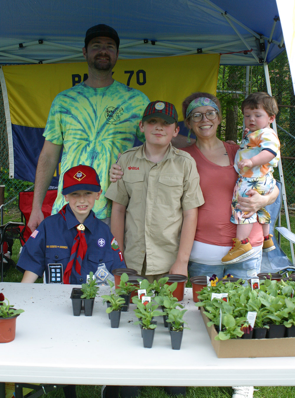 Cub pack 70 sold flowers. Pictured: Scouts Dayton Goslat and Liam Wells, along with Mike Wielins, Rachel Wilson and young Derek Wielins.