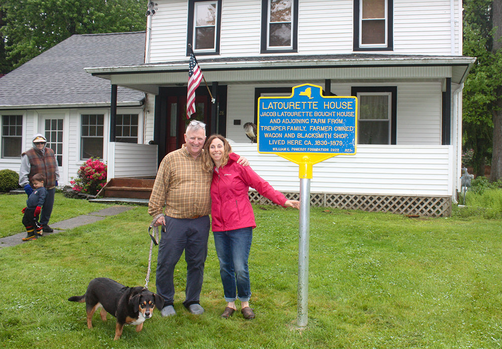 Jim and Lisa Melvlle McIver, with their dog Lovey, in front of their historic home on Berea Road in Walden.