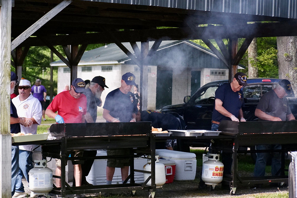 Veterans cooking up hamburgers and hotdogs for attendees of the ceremony 