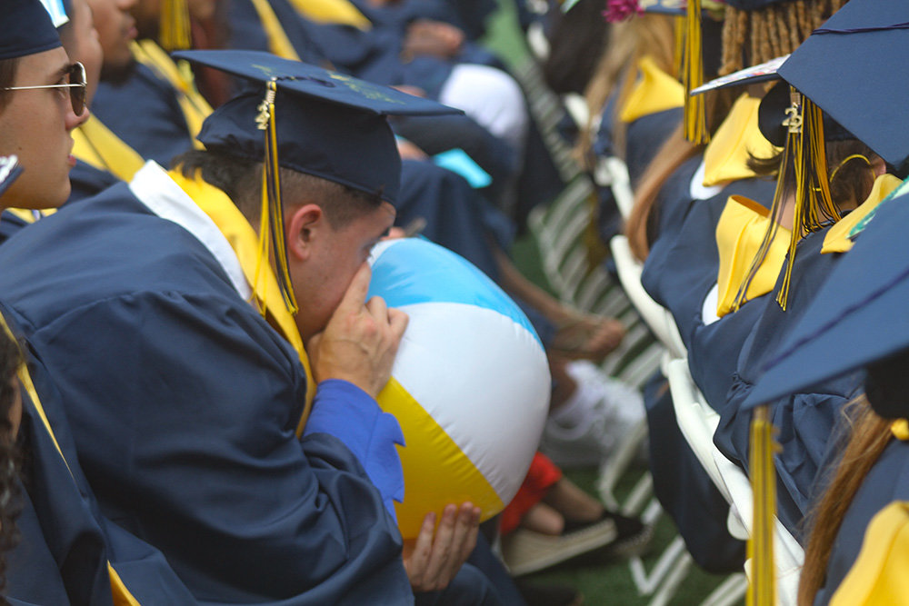Bouncing beach balls have become a part of the graduation tradition.