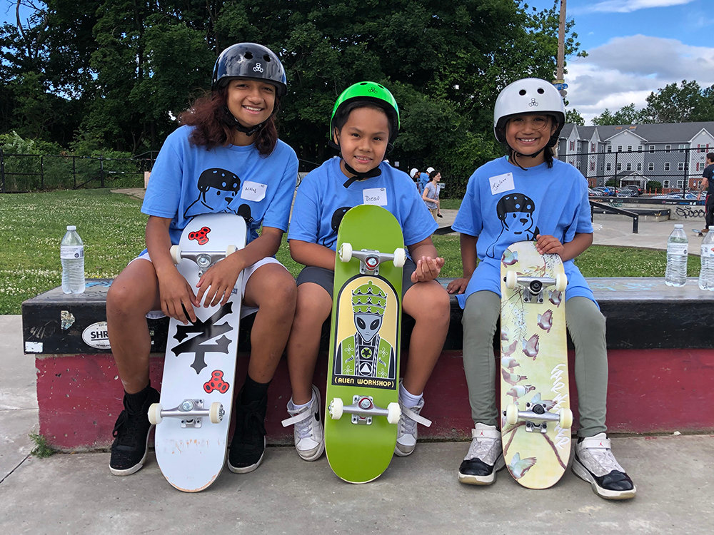 [L-R] Ashley Taroc, Diego Alayo and Jazlynn Caceres with their new boards and gear from the Great Skate Giveaway.