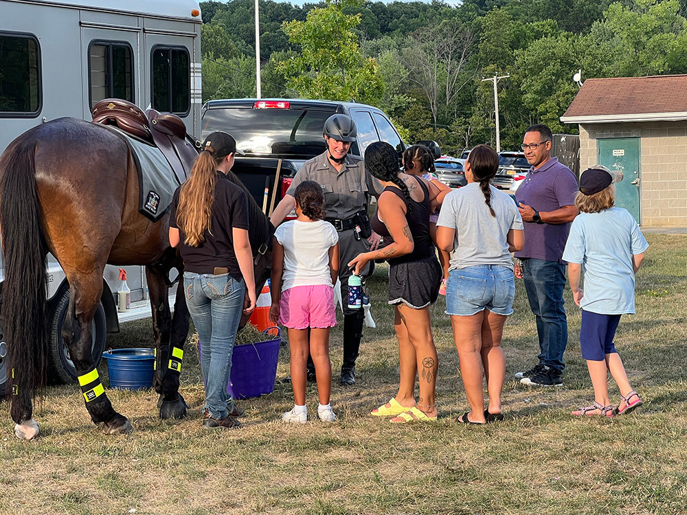 Children speak with the mounted patrol officer and have a chance to meet and pet the police horse.