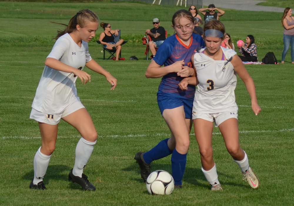 Highland’s Ava Mazzetti and S.S. Seward’s Sophia Brady battle for the ball as Highland’s Raegan Hons looks on during a non-league girls’ soccer game on Sept. 15, 2021 in Florida.