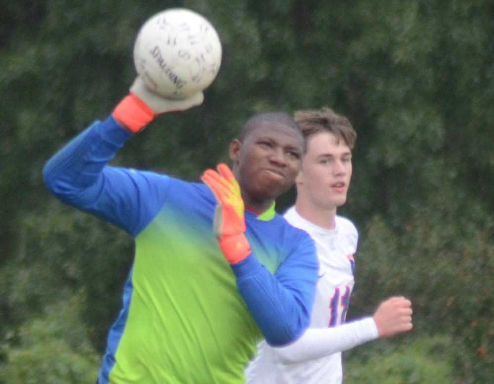 Chapel Field goalkeeper Maurice Davoren throws the ball into play as S.S. Seward’s Joe Buchalski trails the play during Wednesday’s non-league boys’ soccer game at Chapel Field Christian School in Pine Bush.