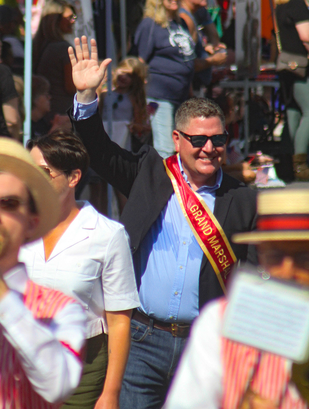 Grand Marshal Marc Devitt waves to the crowd.