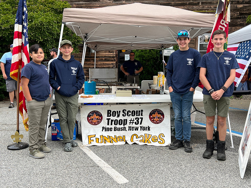 Members of Boy Scout Troop 37 welcome everyone to come and try their famous funnel cake.