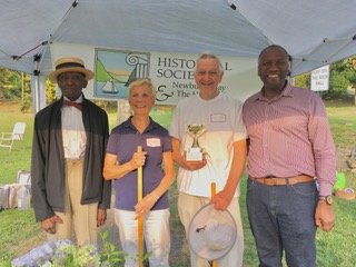 Croquet Tournament winners Pat and Mike Quiana with their trophy stand between Tournament Organizer Roy Spells and City Councilman Anthony Grice.