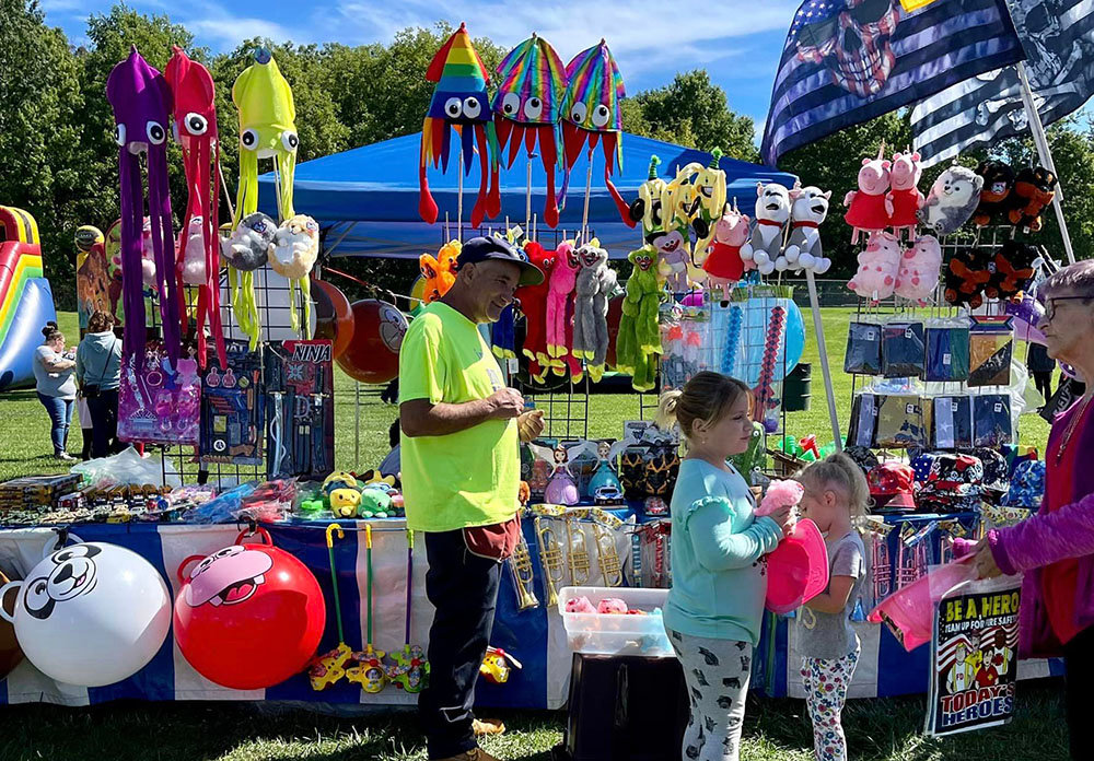 Families browse a variety of toys, trinkets and other items for purchase.