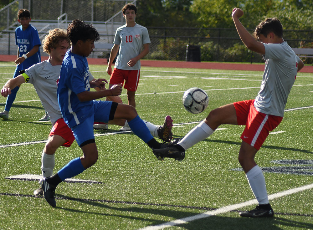 Wallkill’s David Kinzel goes for the ball as Red Hook’s Raphael Senterfit-Sanjuan and J.D. Weishaupt defend and Giacomo Buitoni looks on during Thursday’s MHAL boys’ soccer game at Wallkill Senior High School.