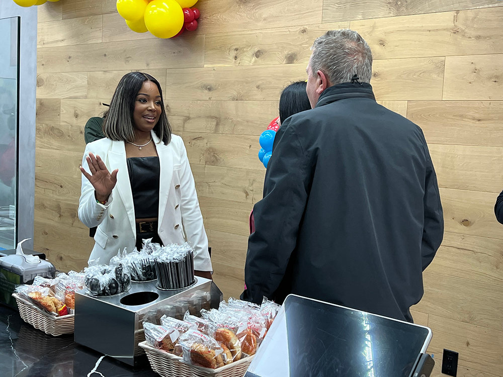 Golden Krust owner Unique Gray [left] welcomed guests to the family and friends gathering on Wednesday, October 5 and showed the store layout and food options.