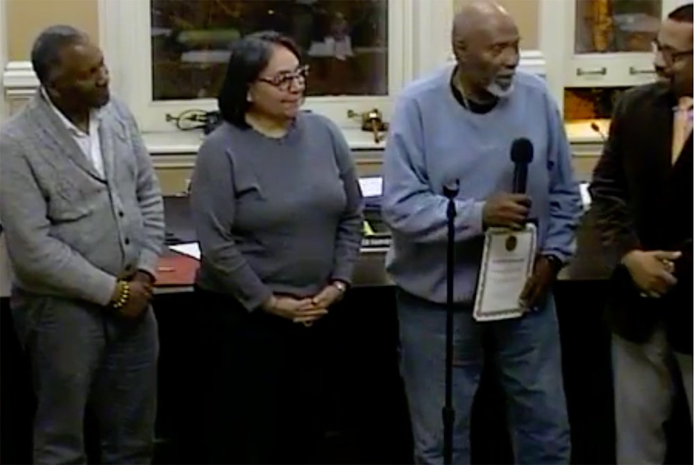 Russell C. Bevier (with microphone) accepts his certificate of appreciation, flanked by Council Members (l. - r.) Anthony Grice, Ramona Monteverde and Mayor Torrance Harvey.