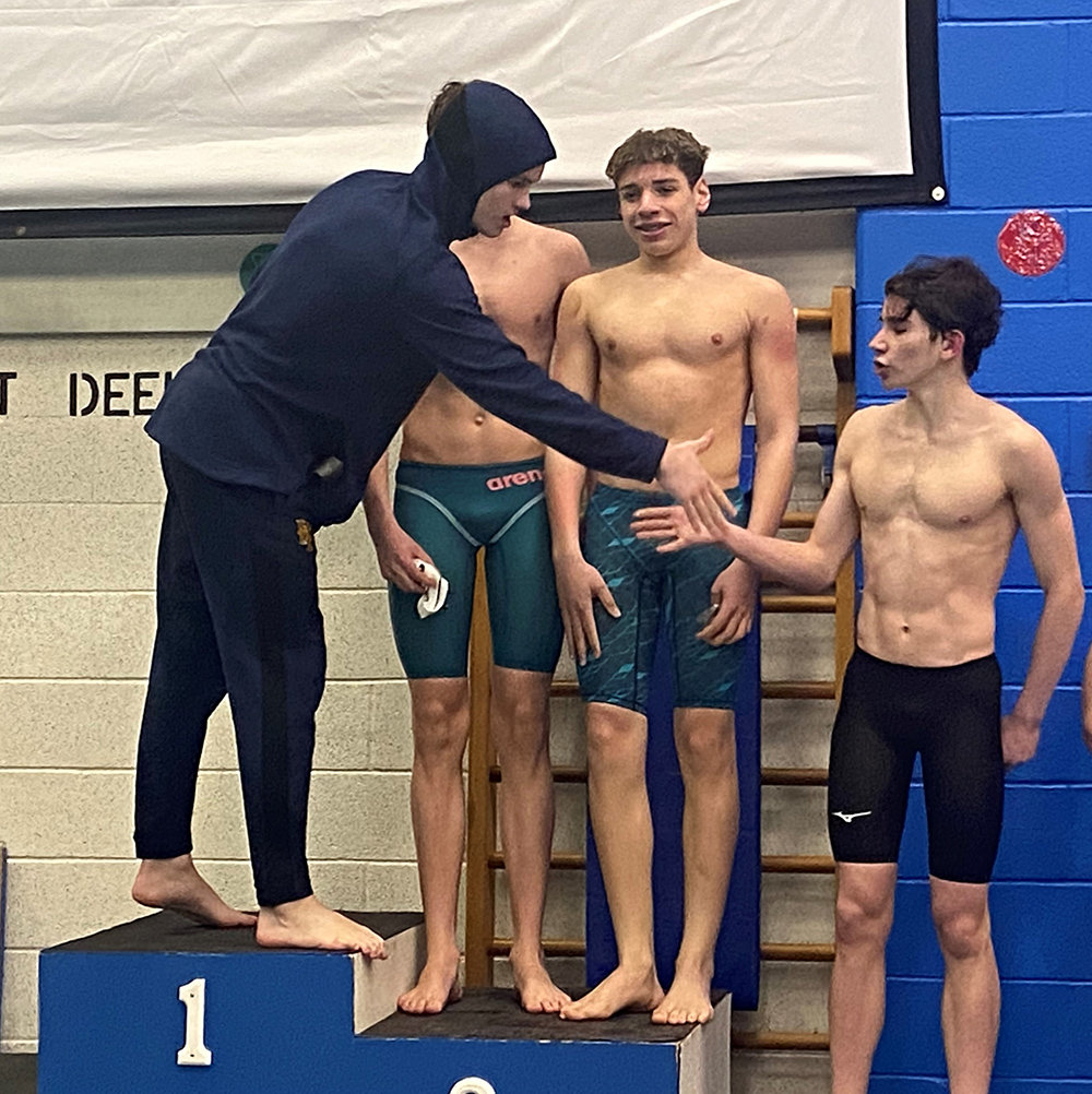 Pine Bush's Tomek Oakes congratulates Newburgh's Jack Mummery as New Paltz' Koby Wulfmeyer and Kingston's Mason Crowley look on during Saturday's Section 9 boys' swimming championship meet at Valley Central High School in Montgomery.