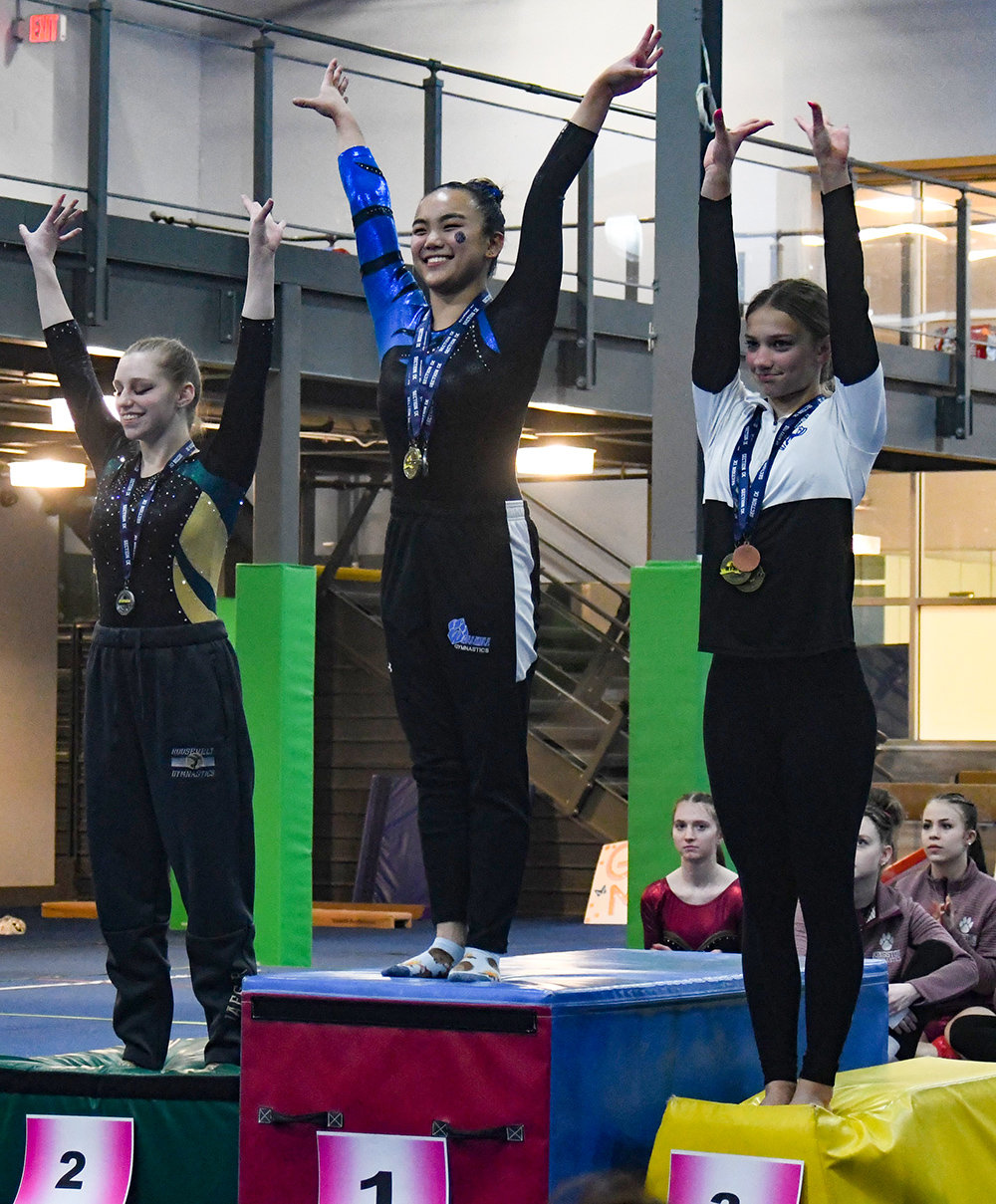 Wallkill's Marlee McCullough stands atop the balance beam podium after the Section 9 gymnastics championships on Feb. 13 at Epik Athletics in Middletown. She is flanked by FDR's Emma Jaeger, left, and Reilly Benson.