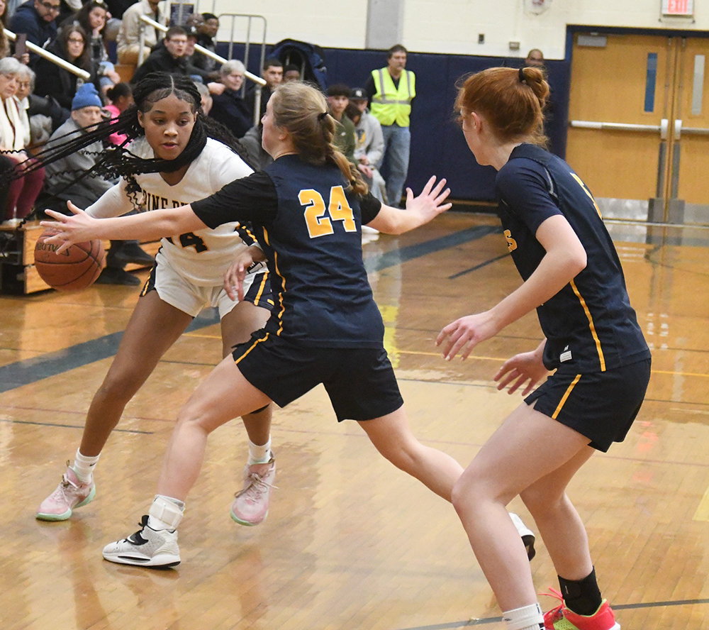 Pine Bush's Ketura Rutty dribbles the basketball as our Lady of Lourdes' Jackie Kozakiewicz (24) defends and Lila Lougren looks on during Saturday's Section 9 Class AA quarterfinal girls' basketball game at Pine Bush High School.