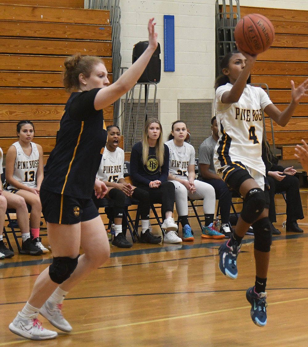 Pine Bush's Mya Watson goes up for a shot as Our Lady of Lourdes' Madison Eighmy defends during Saturday's Section 9 Class AA quarterfinal girls' basketball game at Pine Bush High School.