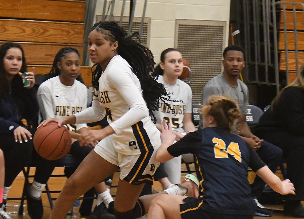 Pine Bush's Ketura Rutty drives past Our Lady of Lourdes' Jackie Kozakiewicz during Saturday's Section 9 Class AA quarterfinal girls' basketball game at Pine Bush High School.