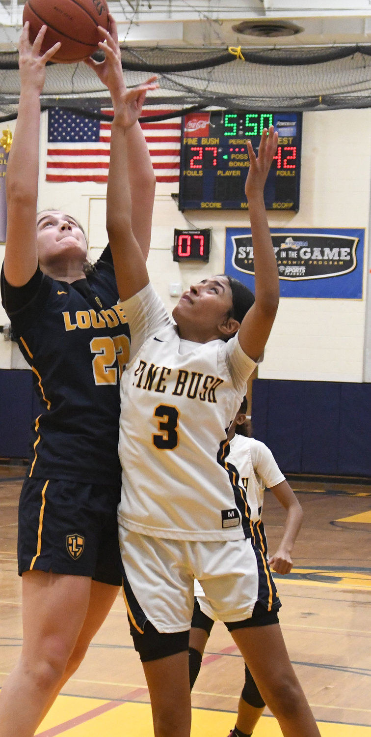 Pine Bush's Leticia Watson battles Our Lady of Lourdes' Simone Pelish for a rebound during Saturday's Section 9 Class AA quarterfinal girls' basketball game at Pine Bush High School.