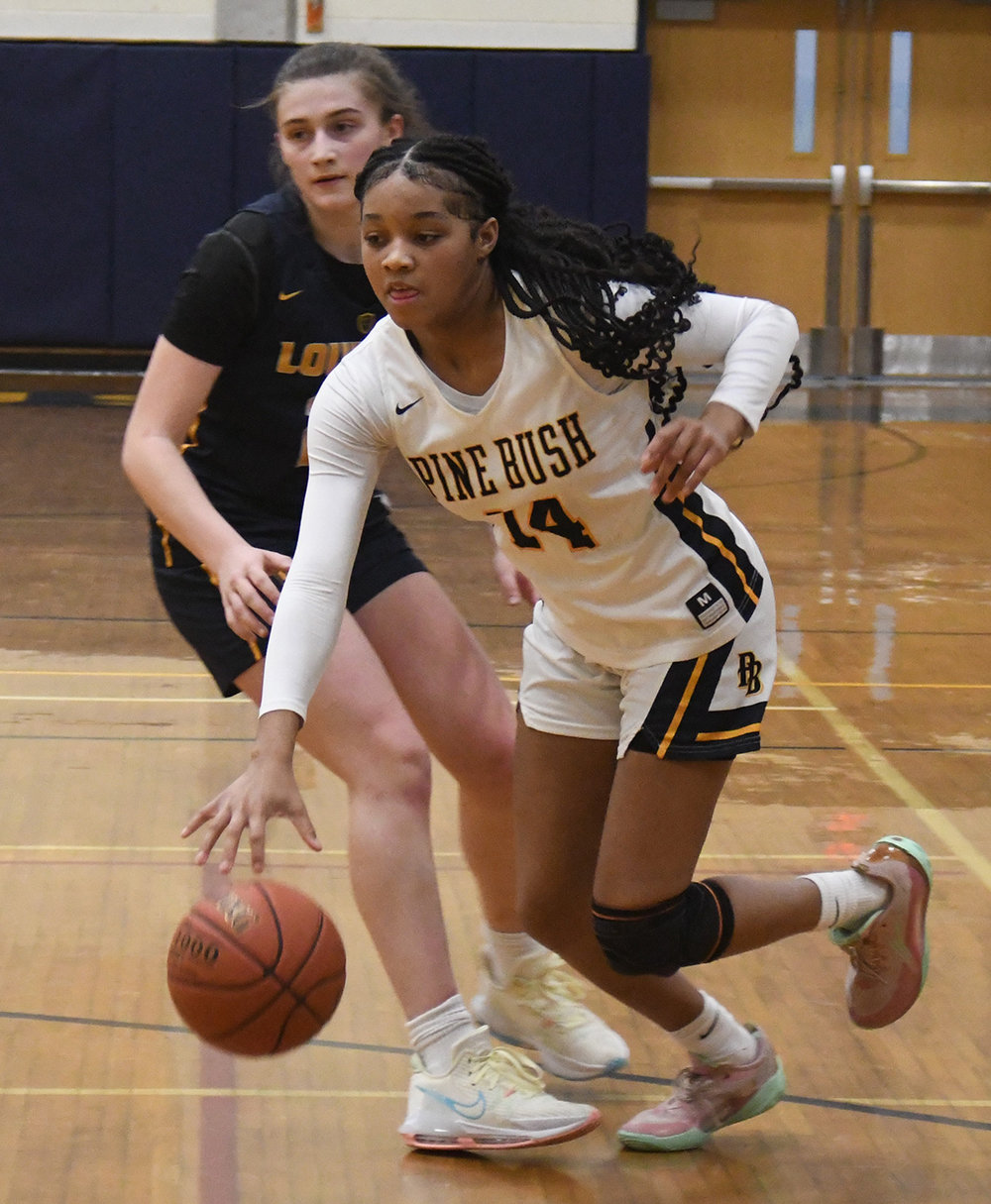 Pine Bush's Ketura Rutty drives past Our Lady of Lourdes' Simone Pelish during Saturday's Section 9 Class AA quarterfinal girls' basketball game at Pine Bush High School.