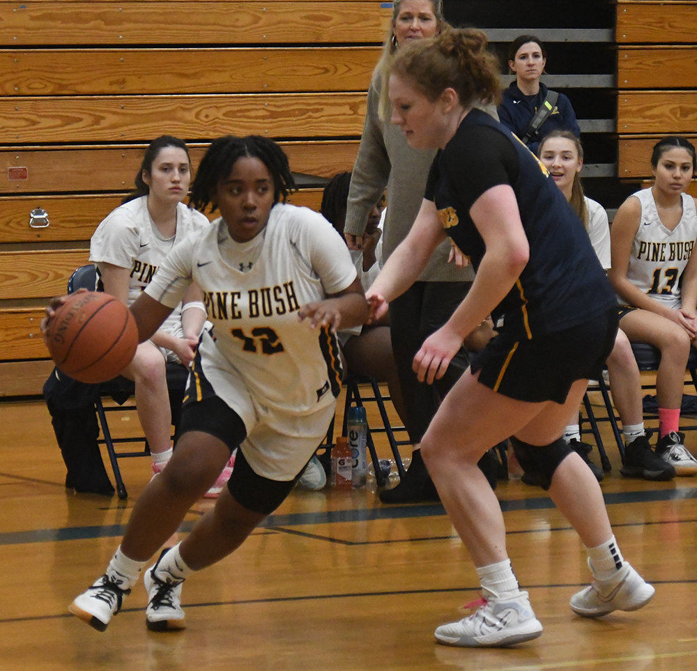 Pine Bush's Jah-esa Stokes drives past Our Lady of Lourdes' Madison Eighmy during Saturday's Section 9 Class AA quarterfinal girls' basketball game at Pine Bush High School.