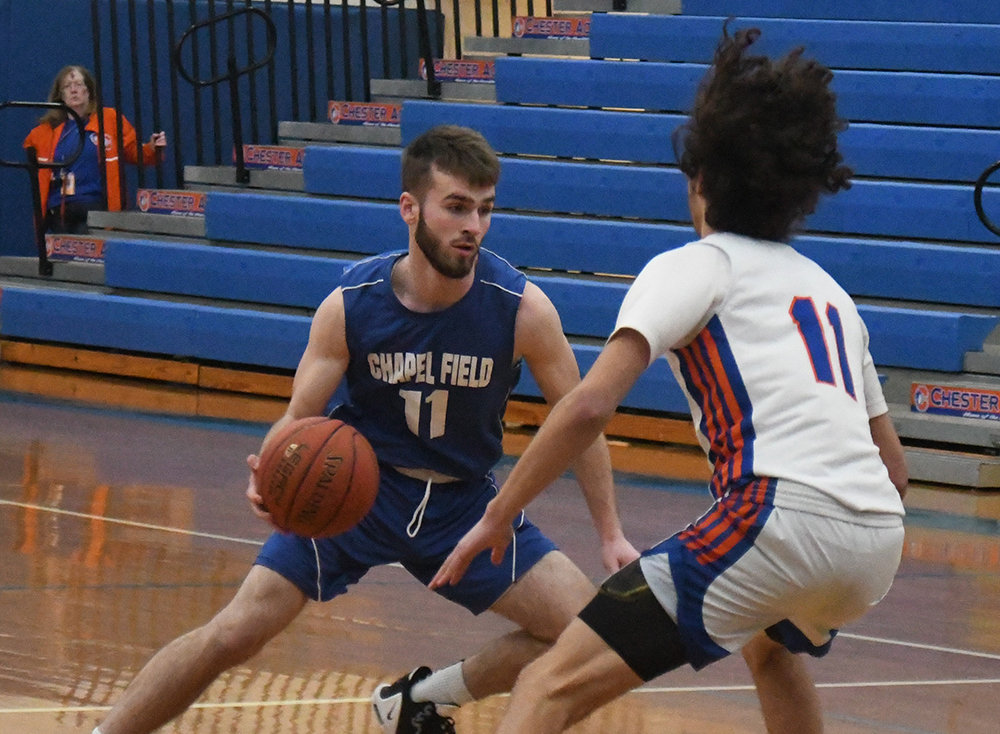 Chapel Field's Mikey Bonagura drives the basketball as Chester's Xavier Espaillat defends during Wednesday's non-league boys' basketball game at Chester Academy.