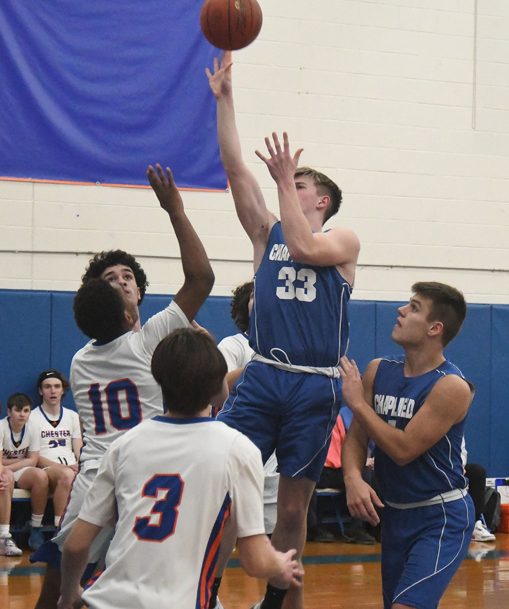 Chapel Field's Jonah McDuffie goes up for a shot as Chester's Andre Jenkins (10), Kieran Hannifan (3) and Dylan Perez defend as Chapel Field's Bryce Hollo looks on during Wednesday's non-league boys' basketball game at Chester Academy.