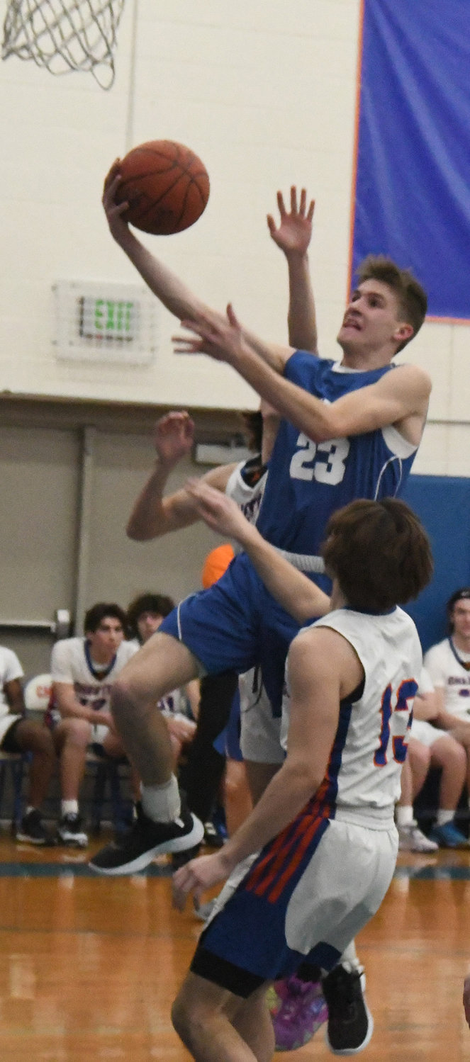 Chapel Field's Noah Swart goes up for a shot as Chester's Nick Garvey (13) and Colin Hannifan defend during Wednesday's non-league boys' basketball game at Chester Academy.