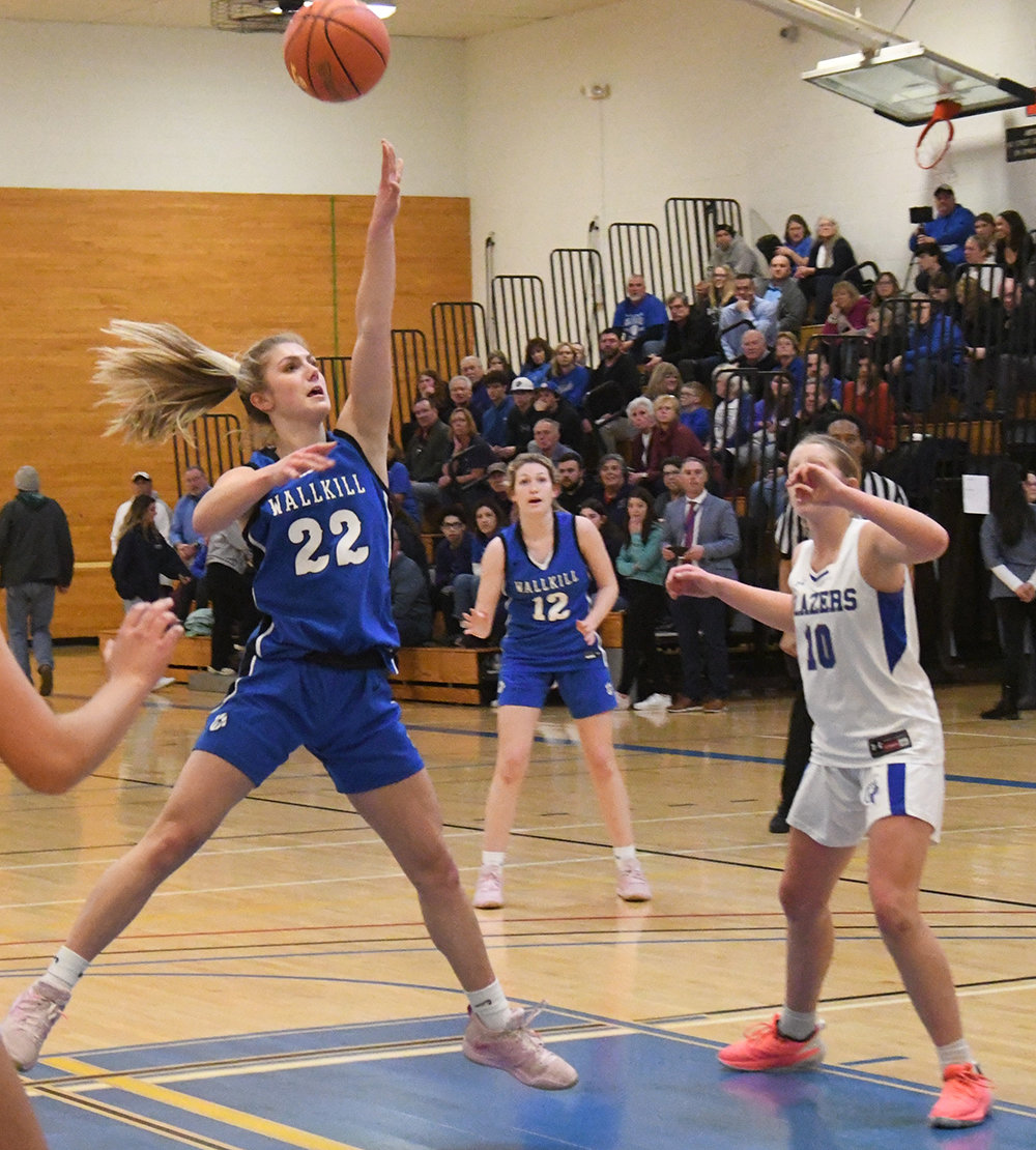 Wallkill's Emma Spindler puts up a shot as Millbrook's Charlie Moore (10) and Wallkill's Alex Dembinsky (12) look on during Thursday's MHAL championship girls' basketball game at SUNY Ulster in Stone Ridge.