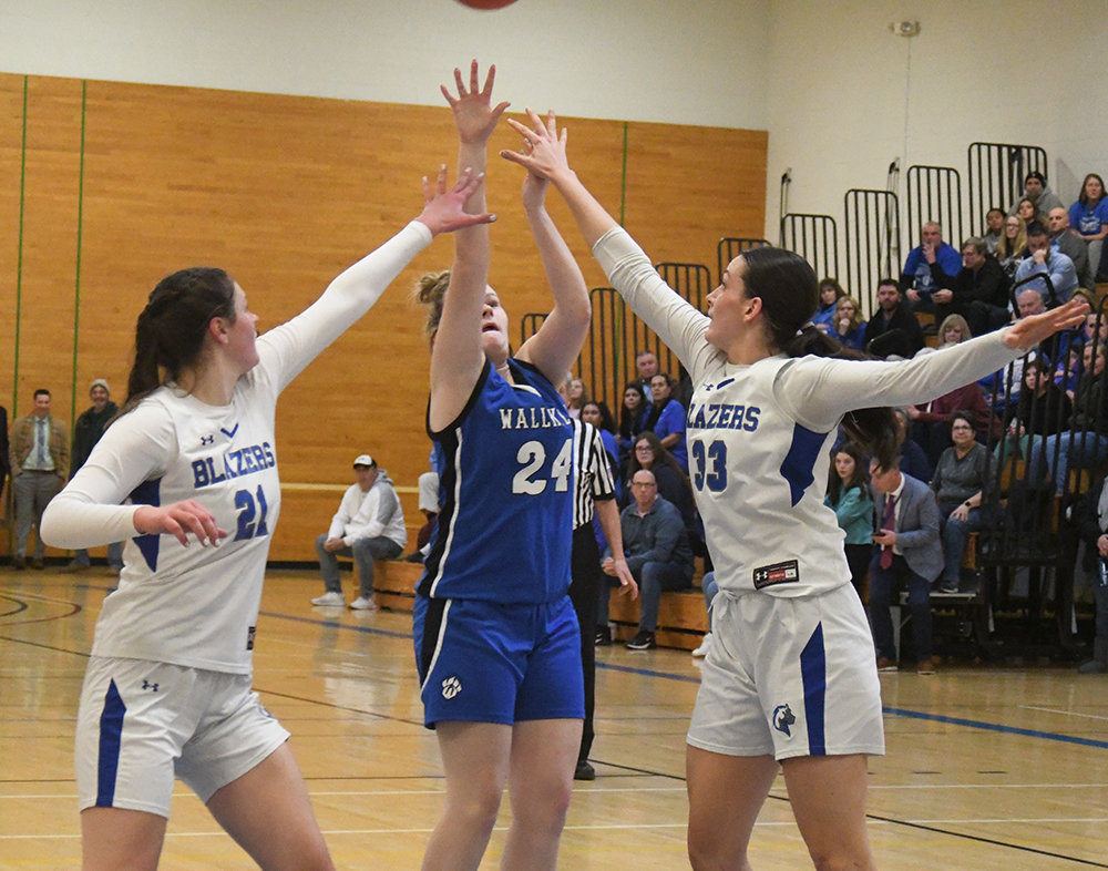 Wallkill's Sam Dembinsky shoots over Millbrook's Natalie Fox (21) and Emily Grasseler (33) during Thursday's MHAL championship girls' basketball game at SUNY Ulster in Stone Ridge.