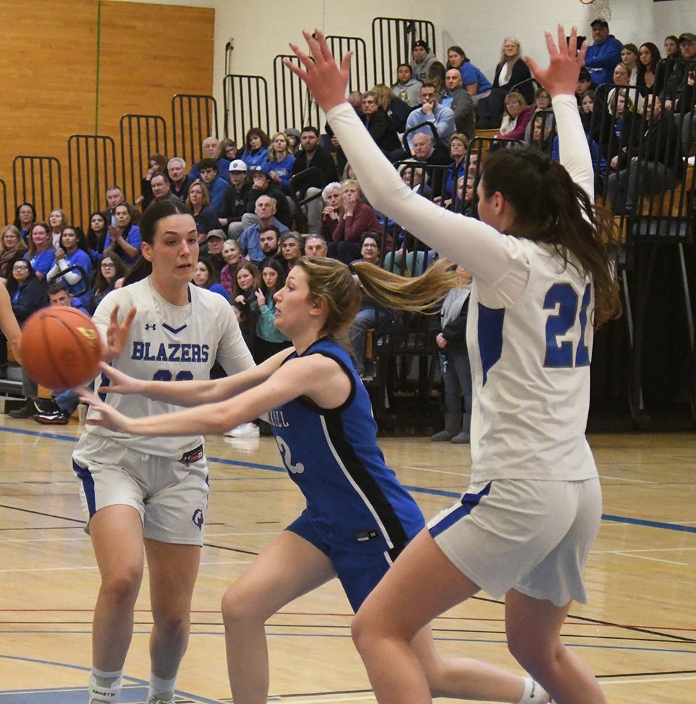 Wallkill's Alex Dembinsky passes off the ball as Wallkill's Emily Grasseler and Natalie Fox (21) defend during Thursday's MHAL championship girls' basketball game at SUNY Ulster in Stone Ridge.