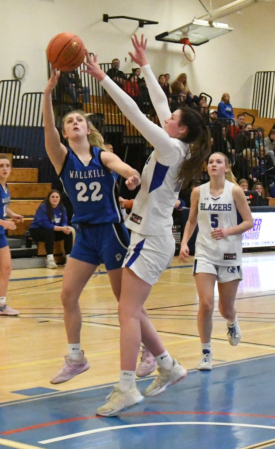 Wallkill's Emma Spindler shoots the ball as Millbrook's Natalie Fox defends and Beth Bosan looks on during Thursday's MHAL championship girls' basketball game at SUNY Ulster in Stone Ridge.