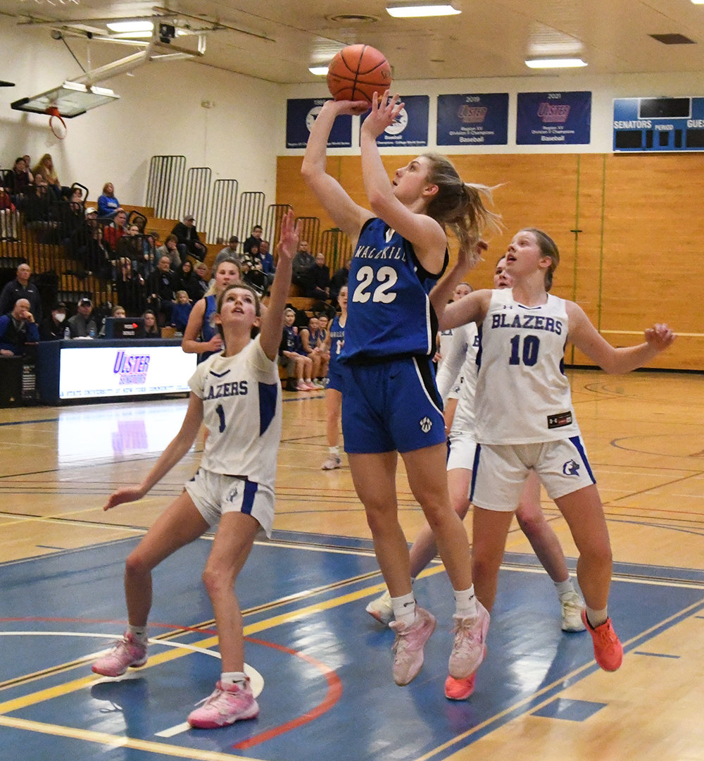 Wallkill's Emma Spindler shoots the ball as Millbrook's Hudson Heitman (1) and Charlie Moore (10) defend during Thursday's MHAL championship girls' basketball game at SUNY Ulster in Stone Ridge.