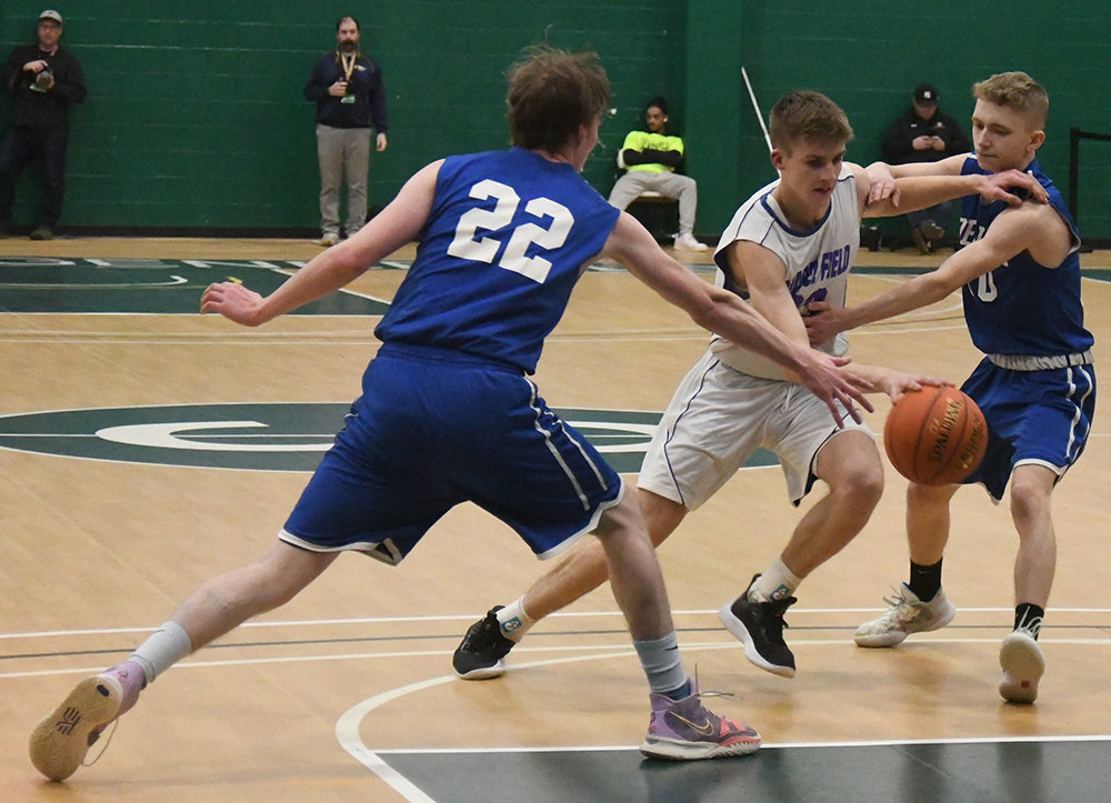 Chapel Field's Noah Swart drives through the defense of Roscoe's Robert Buck (10) and Rudd Hodge during Wednesday's Section 9 Class D championship boys' basketball game at SUNY Sullivan in Loch Sheldrake.