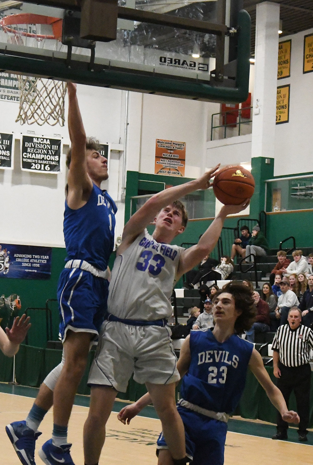 Chapel Field's Jonah McDuffie goes up for a shot as Roscoe's Anthony Teipeike defends and Zach Schwartz (23) looks on during Wednesday's Section 9 Class D championship boys' basketball game at SUNY Sullivan in Loch Sheldrake.