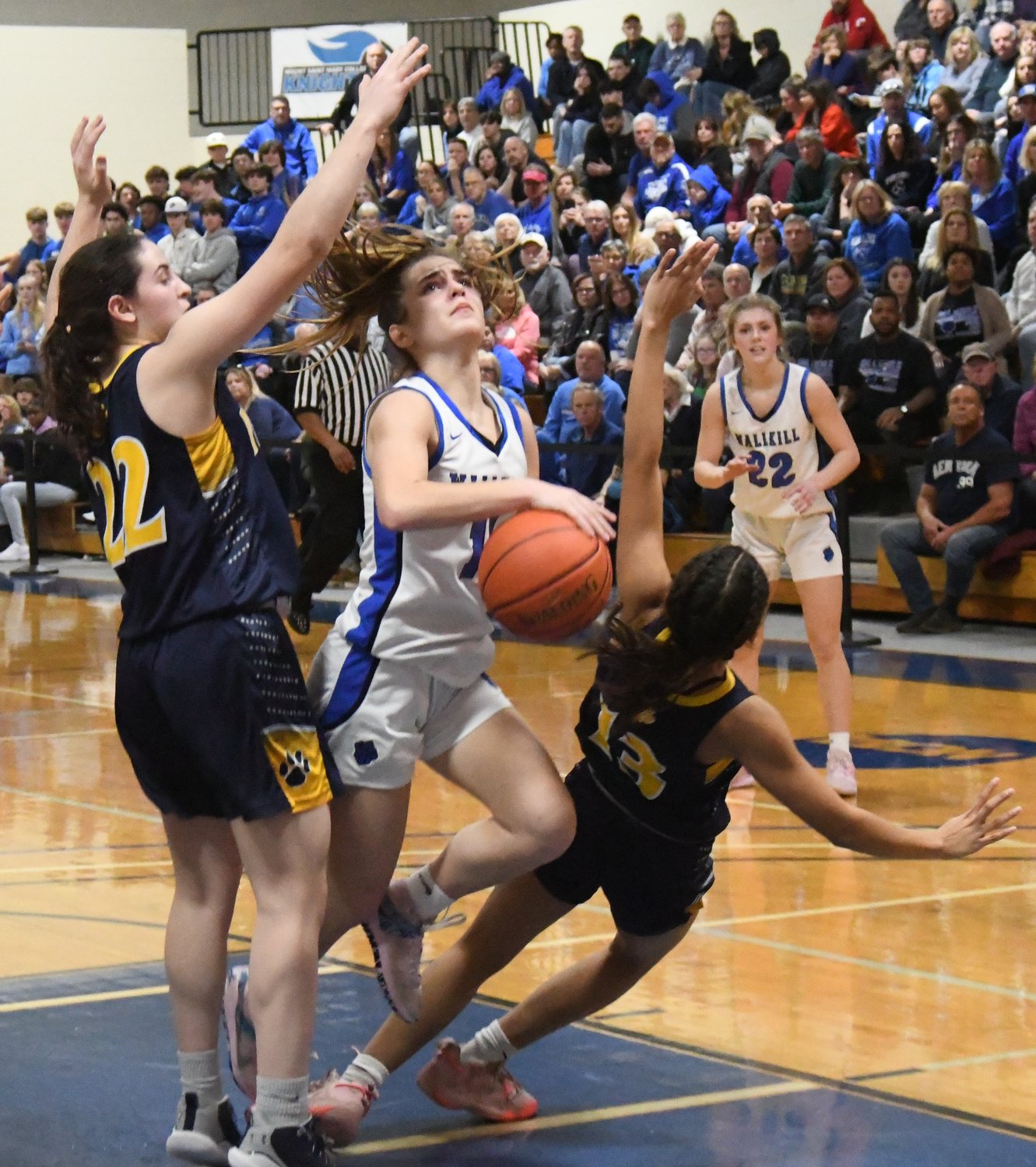 Wallkill's Zoe Mesuch drives through Walter Panas' Julia Gallinger and Sophia Tavarez as Wallkill's Emma Spindler looks on during Saturday's NYSPHSAA Class A regional final at Mount Saint Mary College in Newburgh.