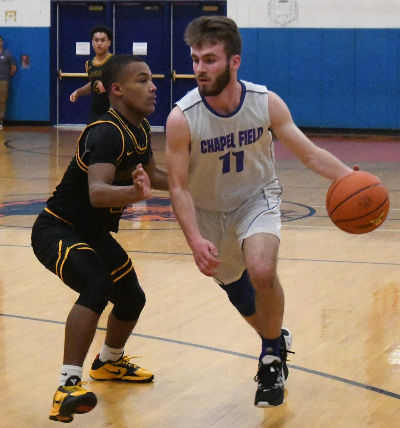 Chapel Field's Mikey Bonagura drives past Bridgehampton's Mikhail Feaster during a NYSPHSAA Class D subregional game on March 7 at S.S. Seward Institute in Florida.