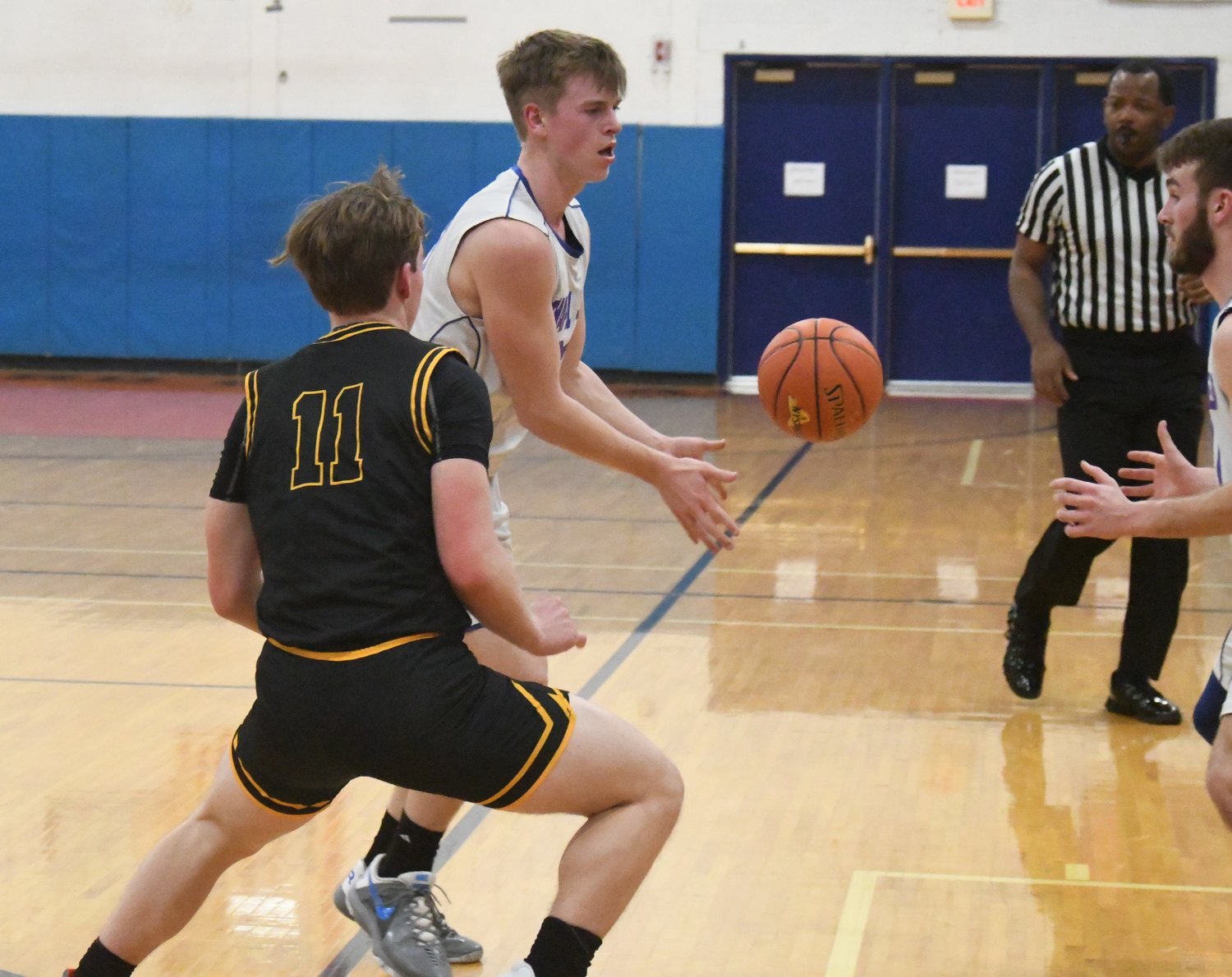 Chapel Field's Jonah McDuffie passes the ball to Mikey Bonagura as Bridgehampton's Dylan Fitzgerald defends during a NYSPHSAA Class D subregional game on March 7 at S.S. Seward Institute in Florida.