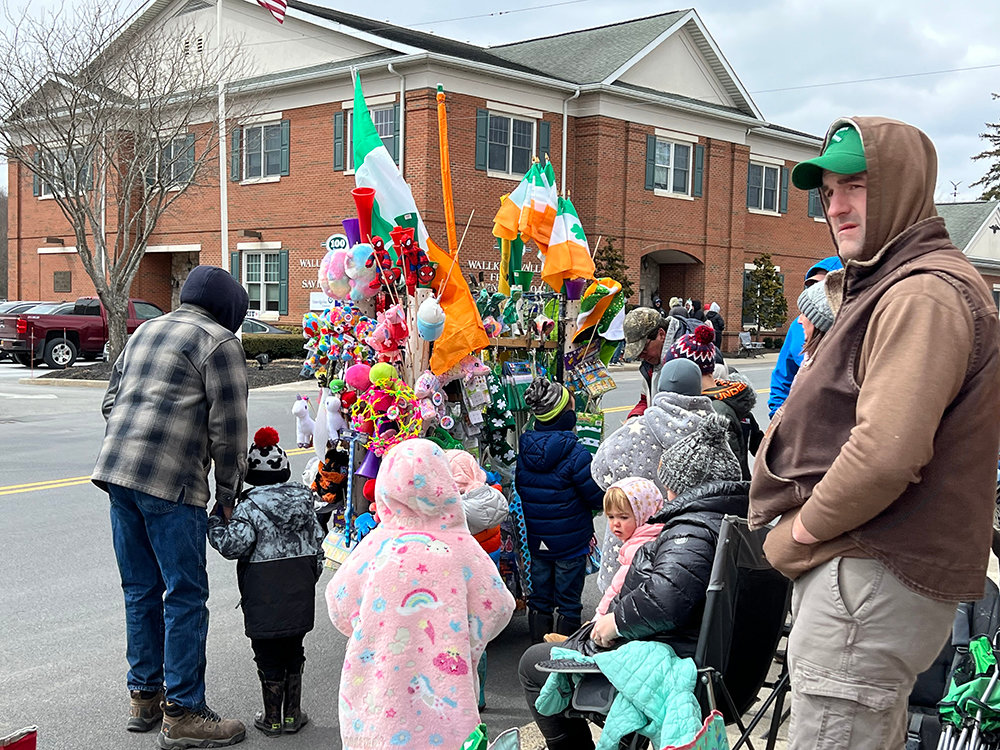 Children stop by a local vendor to hopefully buy a souvenir or some St. Patricks Day merchandise prior to the parade.