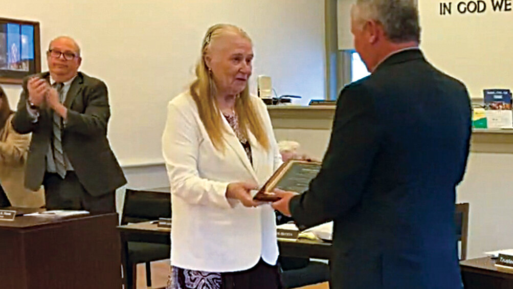 Former Montgomery Village Trustee JoAnn Scheels accepts a plaque from Mayor Steve Brescia at last week’s village board meeting.