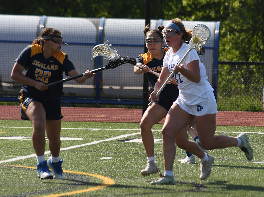 Wallkill's Brianna Merrill runs toward the goal as Highland's Jessica Rendon and Hope Williams defend during Thursday's non-league girls' lacrosse game at Wallkill High School.