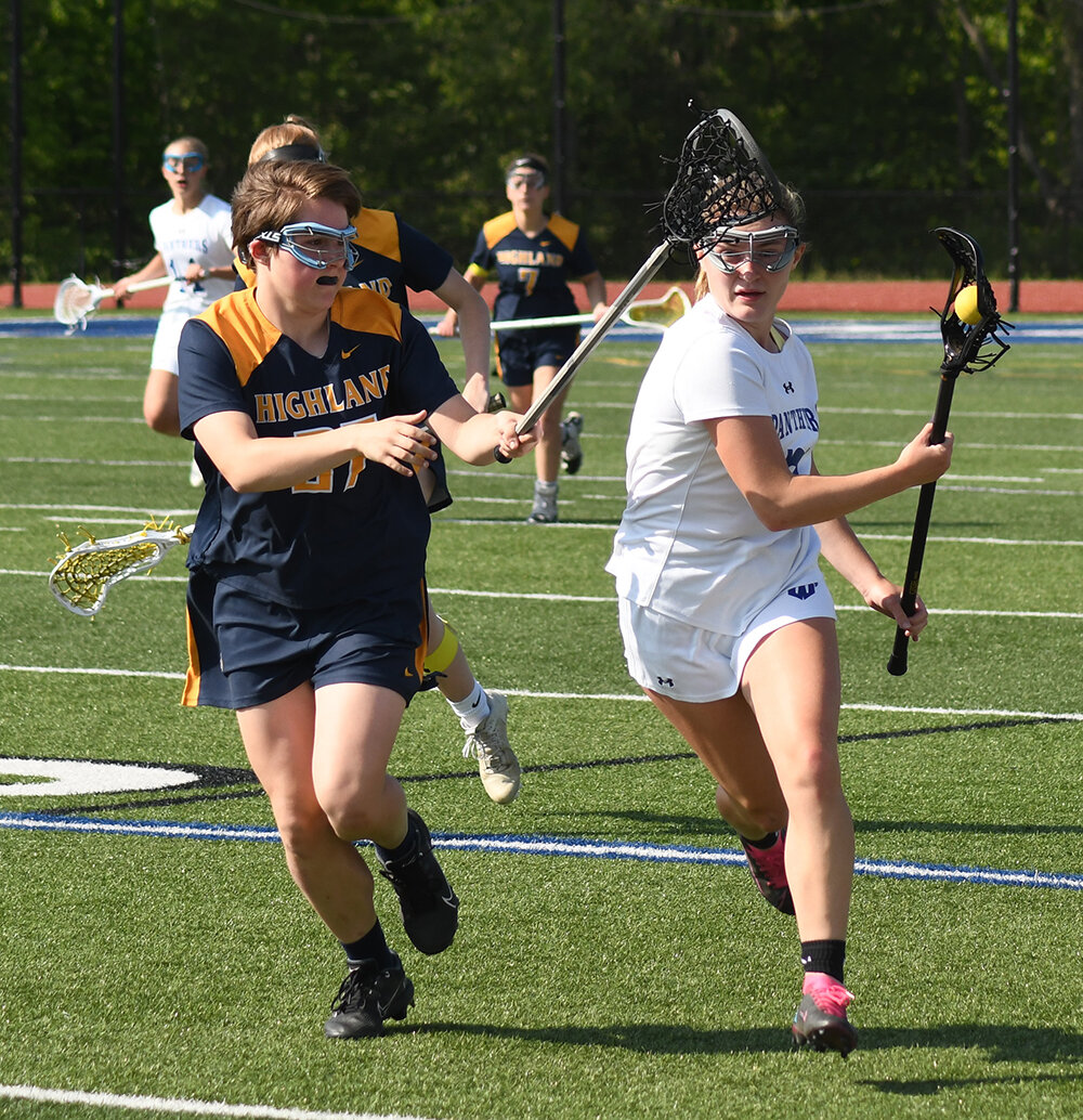 Wallkill's Emma DiLemme brings the ball down the field as Highland's Sophie Murtagh defends during Thursday's non-league girls' lacrosse game at Wallkill High School.